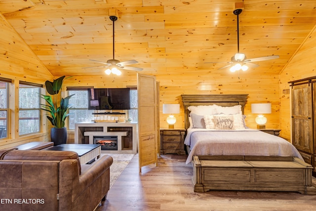 bedroom with wood ceiling, high vaulted ceiling, wood walls, and light wood-type flooring