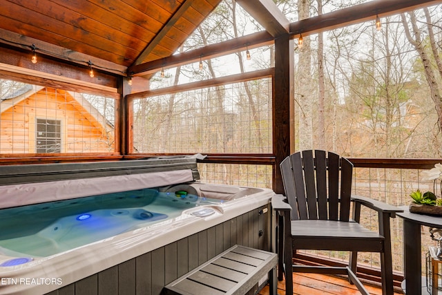 exterior space featuring vaulted ceiling, plenty of natural light, and a jacuzzi