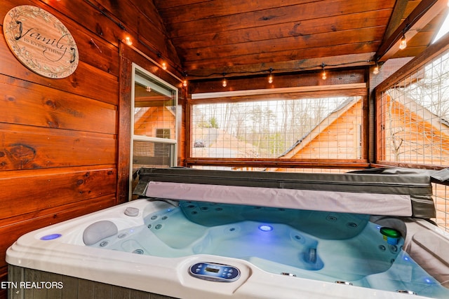 bathroom featuring vaulted ceiling, tiled bath, and wooden ceiling