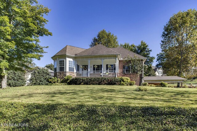 view of front of home featuring a porch and a front lawn