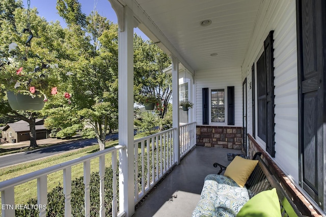 balcony with a sunroom and covered porch