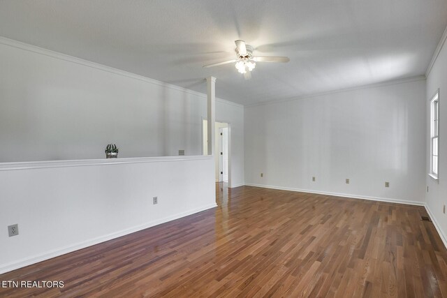 spare room with ceiling fan, crown molding, and wood-type flooring