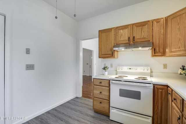 kitchen with light countertops, light wood-type flooring, white range with electric stovetop, and under cabinet range hood