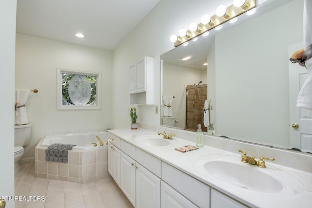 bathroom featuring a garden tub, tiled shower, a sink, and toilet