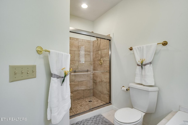 bathroom with toilet and a stall shower