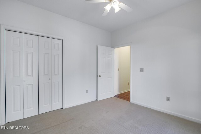 unfurnished bedroom featuring a closet, ceiling fan, and carpet