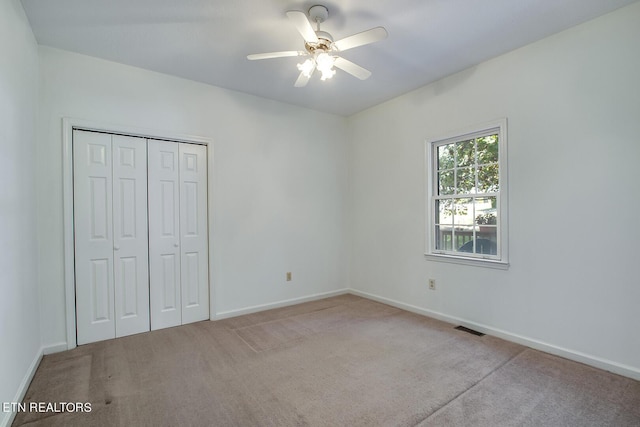 unfurnished bedroom with carpet, a closet, visible vents, and baseboards