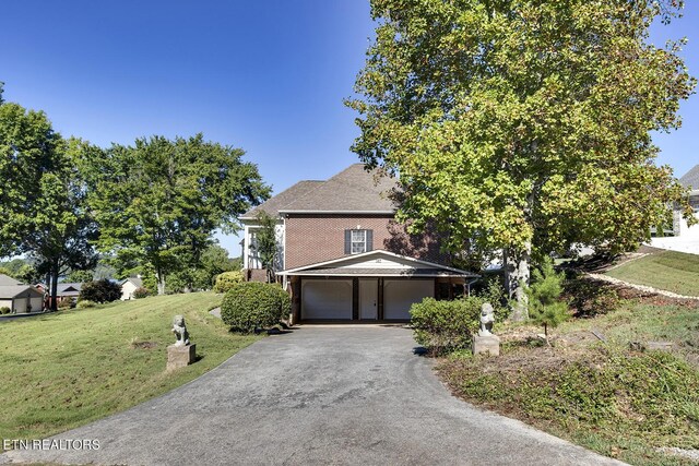 view of front of property with a front lawn and a garage