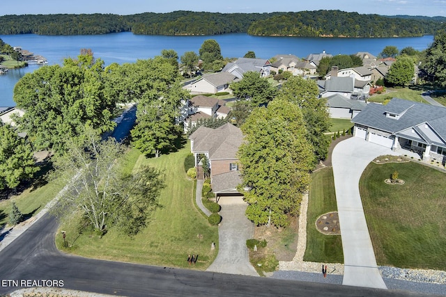 bird's eye view featuring a water view, a residential view, and a view of trees