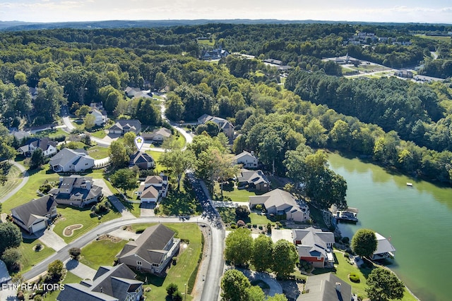 birds eye view of property featuring a water view, a residential view, and a view of trees