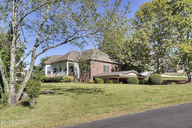 view of property exterior with brick siding and a yard