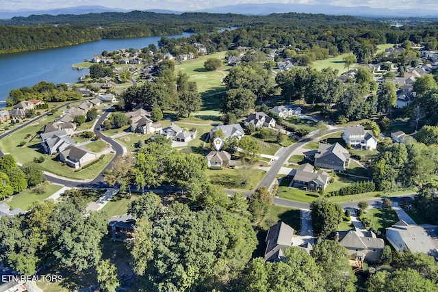 birds eye view of property with a residential view, a water view, and a wooded view