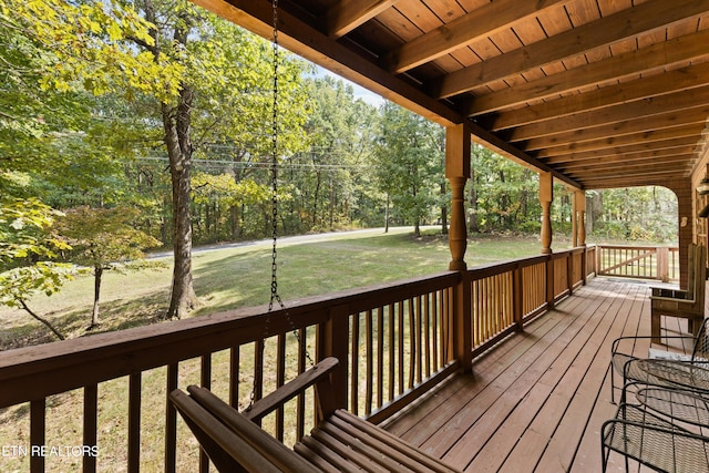 wooden terrace featuring a yard