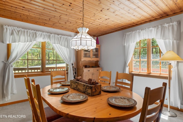 dining area featuring wood ceiling, ornamental molding, and carpet floors