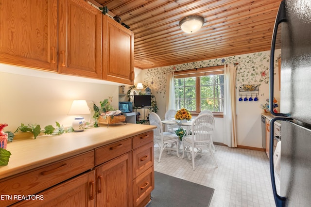 kitchen with black fridge and wooden ceiling