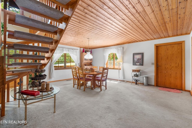 carpeted dining room with wooden ceiling