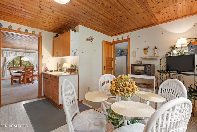 carpeted dining area featuring wood ceiling