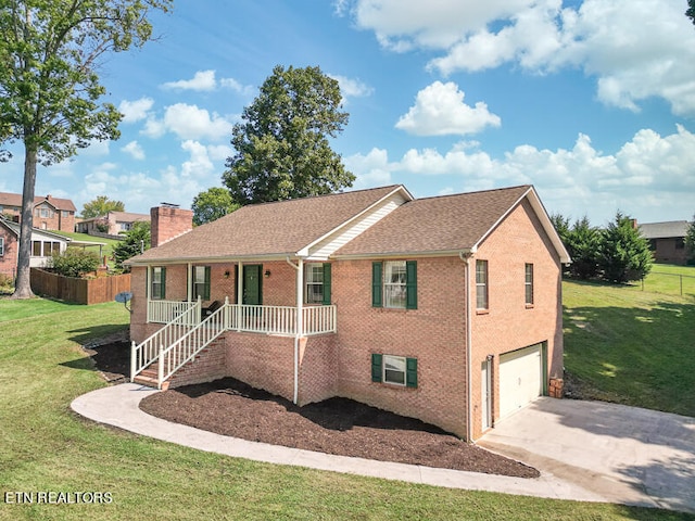 view of front of property featuring a garage, a front lawn, and covered porch