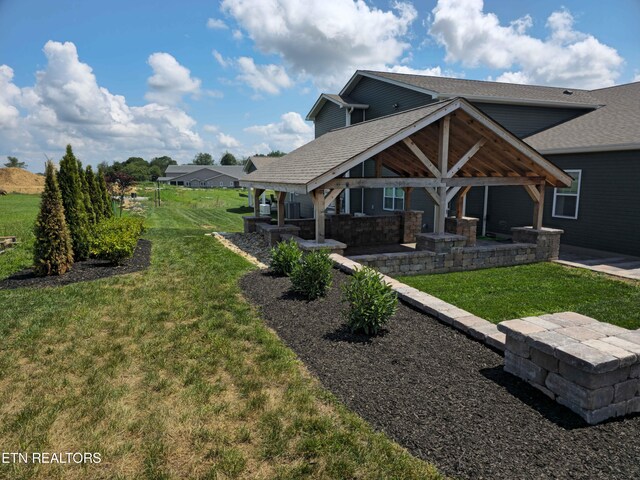 rear view of house featuring a yard, a patio, and a gazebo