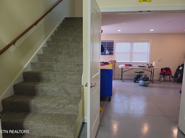 stairway with concrete flooring, baseboards, and recessed lighting