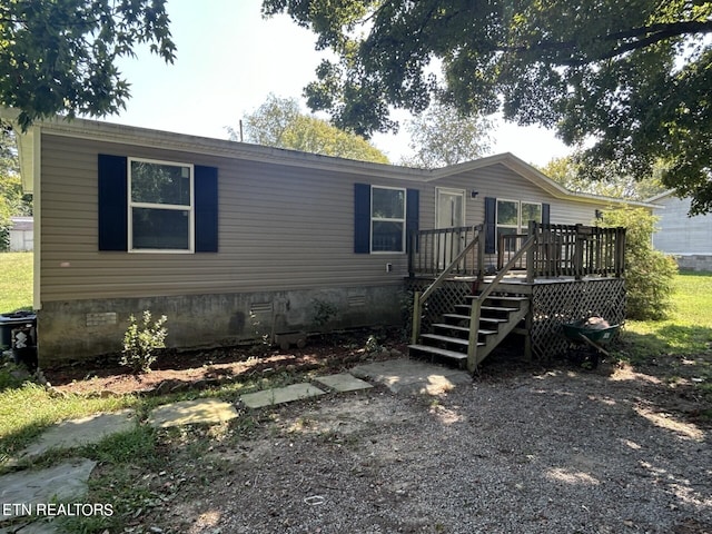 rear view of house with a wooden deck