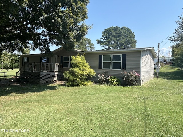 view of front of home featuring a deck and a front yard