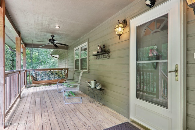 wooden terrace featuring a porch and ceiling fan