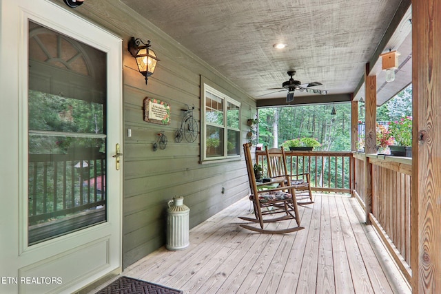 wooden deck with ceiling fan and covered porch