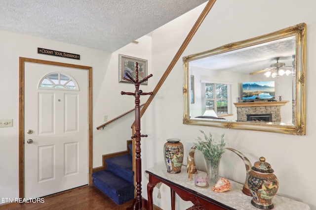3138 Cool Creek Rd, Sevierville, TN 37862 - entryway with dark wood finished floors, a stone fireplace, stairs, and a textured ceiling