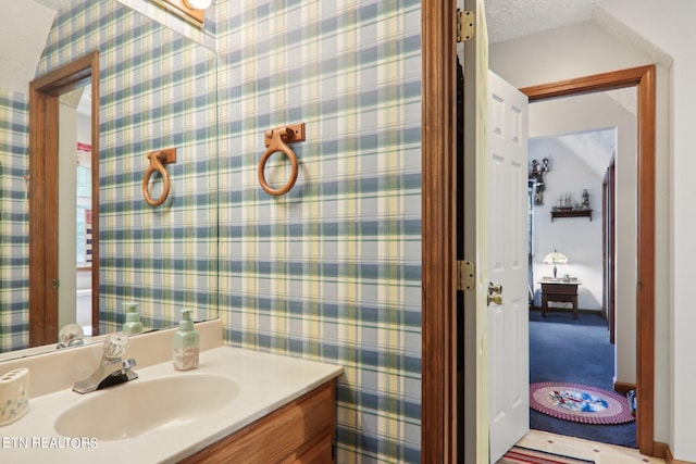 bathroom with vanity and a textured ceiling