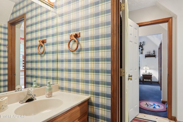 3138 Cool Creek Rd, Sevierville, TN 37862 - bathroom with wallpapered walls, vanity, and a textured ceiling