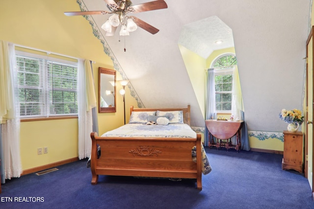 carpeted bedroom with multiple windows, lofted ceiling, and ceiling fan