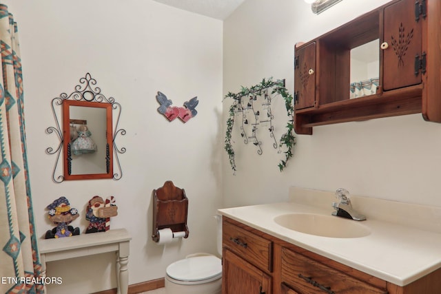 bathroom featuring vanity and toilet