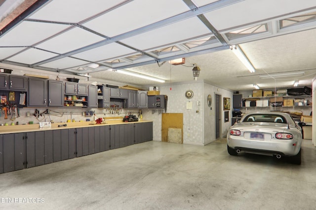 garage featuring a workshop area and a garage door opener