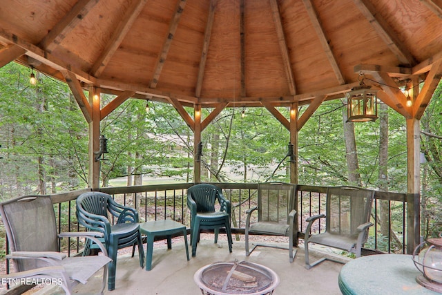 wooden deck with a fire pit and a gazebo