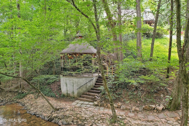 view of yard featuring a water view and a gazebo