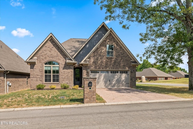 view of front of property with a front lawn and a garage