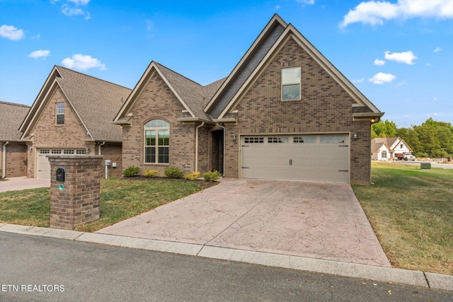 traditional home with brick siding, a front yard, concrete driveway, and roof with shingles