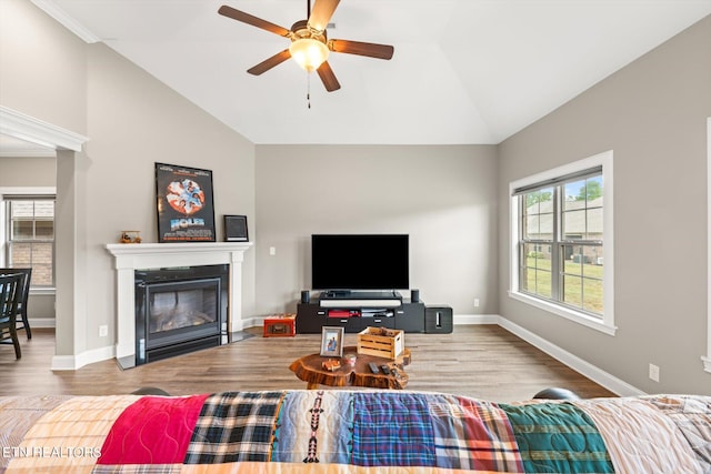 living room with vaulted ceiling, wood-type flooring, and ceiling fan