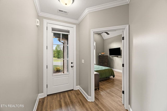 doorway featuring crown molding and dark wood-type flooring