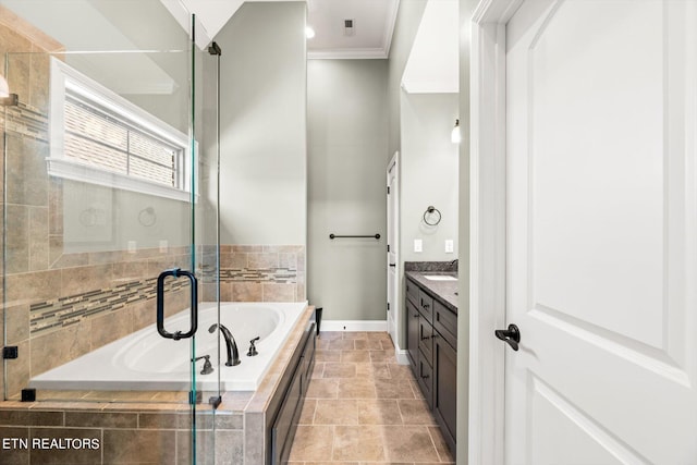 bathroom featuring crown molding, a shower stall, baseboards, vanity, and a garden tub