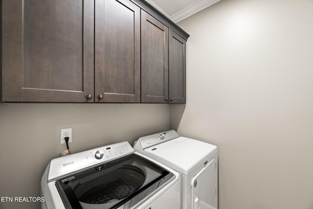 laundry area with cabinets, ornamental molding, and washing machine and dryer