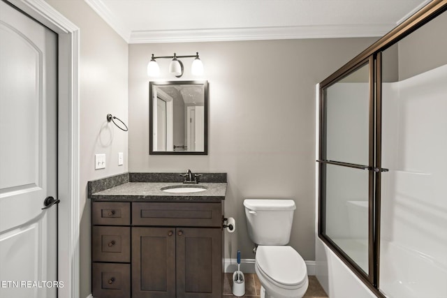 full bathroom featuring ornamental molding, vanity, toilet, and enclosed tub / shower combo