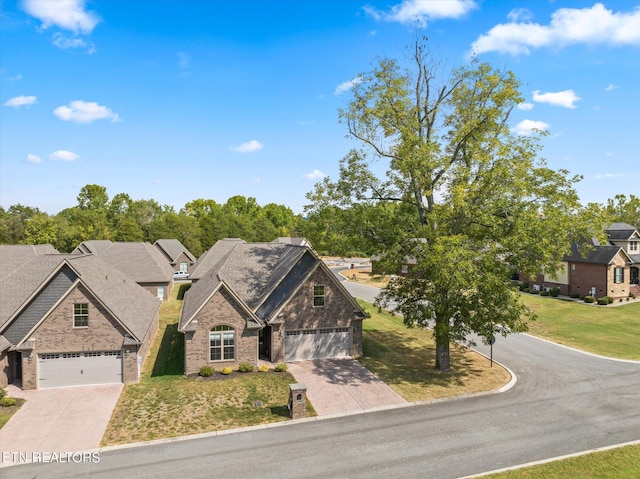 view of front of home with brick siding, driveway, and a front lawn