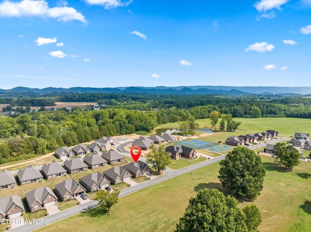 aerial view featuring a residential view, a wooded view, and a mountain view