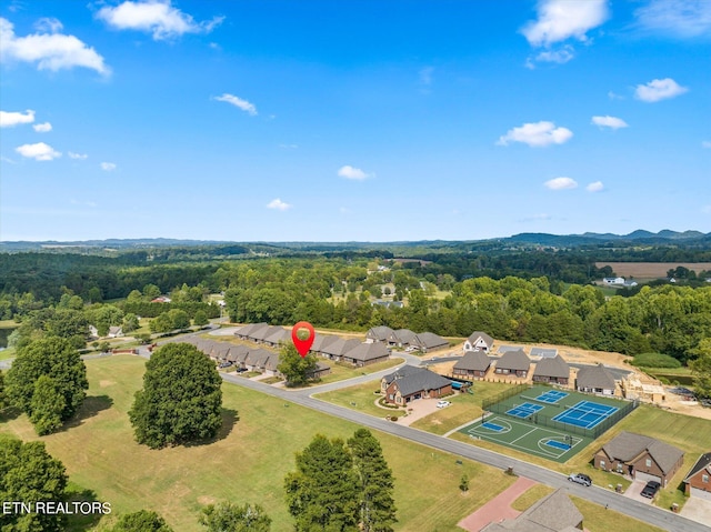 bird's eye view with a wooded view