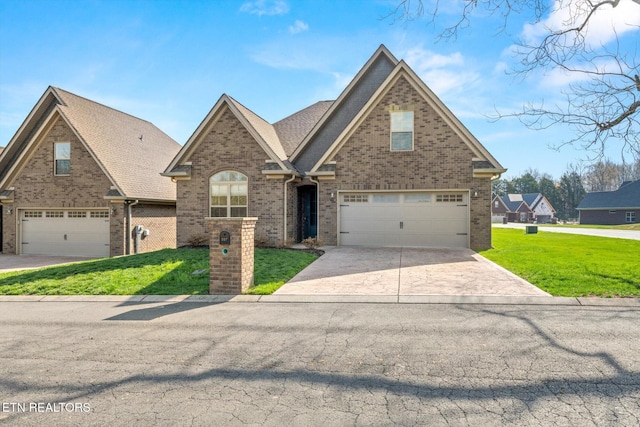 view of front of home with brick siding, a garage, concrete driveway, and a front yard