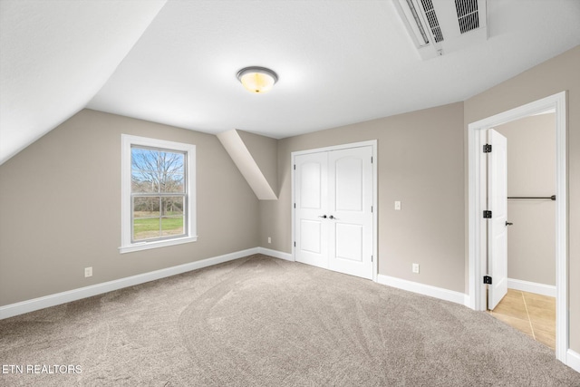 bonus room featuring baseboards, lofted ceiling, visible vents, and carpet