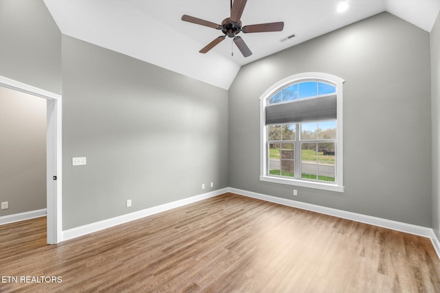 spare room featuring baseboards, wood finished floors, and ceiling fan