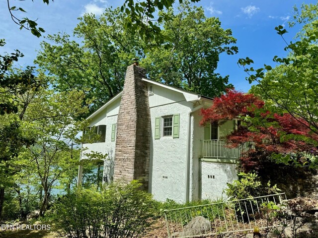 view of side of home with a balcony